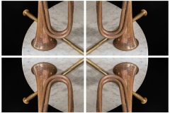 a kaleidoscope-like reflective image of 4 panels depicting a copper-patina bugle horn, and the brass piece of another instrument