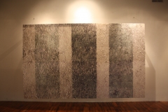 Image of installation at MAP Gallery in Easthampton. Large ink drawing hovers above floor. Many segments of patterned abstraction combine to form three darker vertical strips and 4 light strips