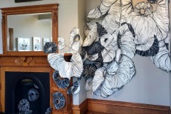 Site specific Installation at the Newport Art Museum. An overlapping stream of flowery, muscle tissue like donut forms overlap and rise up a wall.
