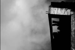 Black and white photograph of a closeup of a barn