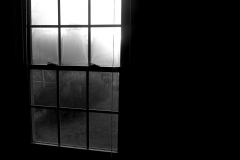 Black and white photograph of a window with shadows