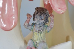 Showing girl poised on claw base.
