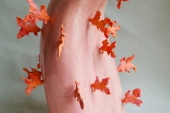 Pink tongue form with orange goldfish forms and glass droplets attached to surface.