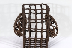 Open cage grid form with pod protrusions and eyeballs attached.