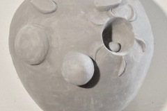 Simplified Clown head, with round eyes and nose and no mouth.