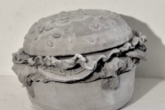 Hamburg form with lettuce, tomato, on sesame seed bun.