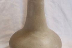 Vase form with wide round bottom and tall narrow neck.