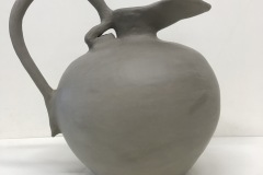 Large pitcher form with arched handle and extended spout.