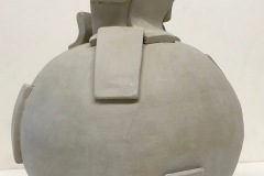 Round vase form with rectangular tile pieces on surface and forming neck of the form.
