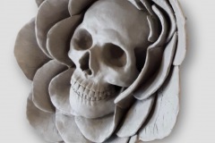 Sculpted skull form set within a flower form.