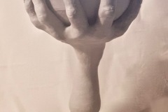 Pedestal form with cup portion held by sculptured hand with long fingernails.