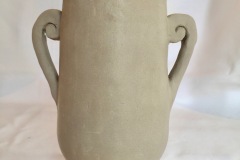Tall pedestaled jar with curled decorative handles and fluted knob.