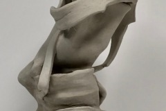 Tall sculpture with appears to be in the process unravelling with ribbon like structures used throughout.