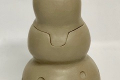 Tall jar formed with 4 circular shaped getting smaller at the top.