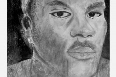 self portrait of a man looking at the viewer. the tonal range is lesser, an overall lighter shading details the mans contours. a football is peeking in the background!