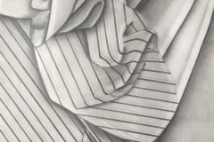 A calculated pencil drawing of a striped fabric draped atop another fabric. the folds change the direction of the stripes and creat shadows atop the other fabric.