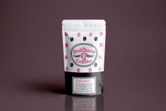 Product design for a bag of light roast coffee called “Dollface Coffee”. There is a pink and black coffee bean pattern on the bag surrounding the logo depicting a doll’s face.