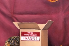 Still life. Atop a deep ruby cloth sits a cardboard box with a FRAGILE sticker on it. Peeping from behind the box is an inquisitive box turtle who is staring at the viewer. A couple maple leaves fall in the air.