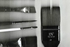 Blurred scan of six paint brushes arranged in columns and rows.