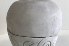jar form, set on feet, with spiral carving at base and spiral handle.