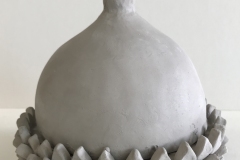 acorn shaped jar form with textured bottom and smooth top.