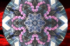 A mandala with 3D illusion and hint of tartan patterning.