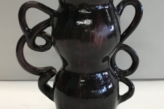 vase form with two twisted handle on either side, glazed deep purple.