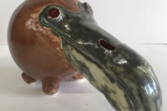 toucan head  form with brown and dark green glaze.
