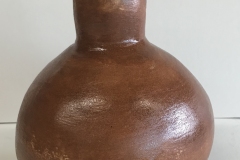 Spherical form with funnel shaped top, finished with black and brown glaze.