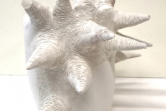 vase form with large hairy horn protrusions.
