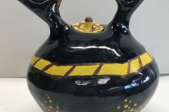 Large jar form with sprouted handle glazed yellow, black and brown.