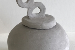 Small round jar form with double looped handle.