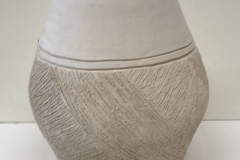 oval vase form with highly textured bottom.