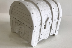 box in the shape of a treasure chest with octopus carved on sides.