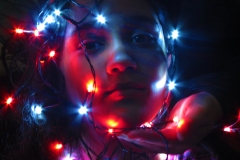 girl with lights around her face.
