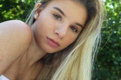 image of a young womans face looking over her shoulder.