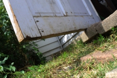 image of an old door ajar from below.