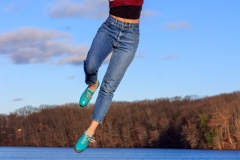 freeze frame image of tap dancer mid jump.