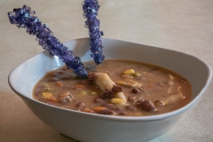 image of soup with purple rock candy sticks poking out.
