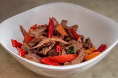 image of meat and onion sautee with twizzlers.