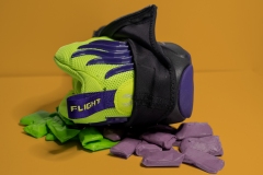 colorful neon sneaker laying atop bed of matching purple and green taffy.