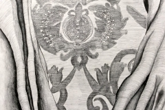 still life of fabric folded back to reveal a paisley print.