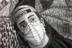 portrait of a man with a mask on, among a hillside of trees. on the other side is a hillside of burnt trees.