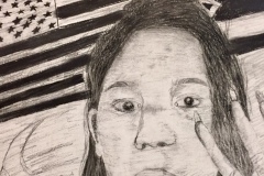 Self portrait of a woman with her hand up, two flags converge in the background behind her head.