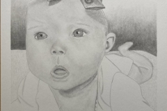 Graphite value drawing of an infant laying on her stomach with a look of wonder on her face.