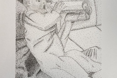 An infant drinks milk from a bottle being held by her uncle.