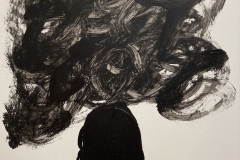 silhouette of a human head and shoulders, with a swirley cloud above the head.