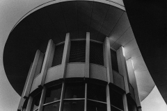Grainy black and white photograph of the top of the tower of a building