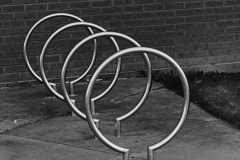 black and white photo of a metal bike rack