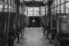 black and white photo of the inside of a bus or trolley.